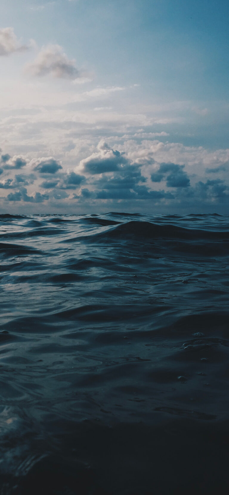 Default wallpaper of Dark ocean under a cloudy sky